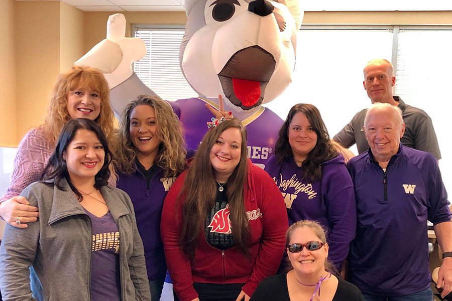 About Our Agency - View of Mosaic Insurance Team Posing with Mascot in the Office