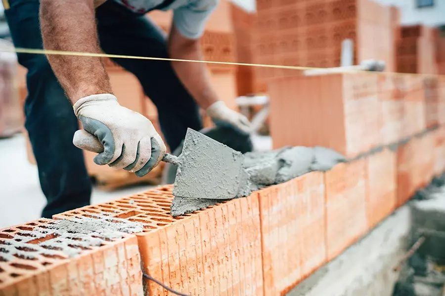 Masonry-Contractor-Insurance-Professional-Masonry-Worker-Using-Pan-Knife-for-Building-Brick-Walls-with-Cement-and-Mortar
