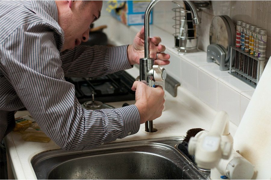 Plumber Insurance for Your Business - Plumber Fixing a Kitchen Sink Faucet