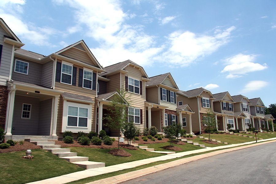 Homeowners-Association-Insurance-A-Row-of-Newly-Constructed-and-Professionally-Landscaped-Townhomes-on-a-Bight-Sunny-Day