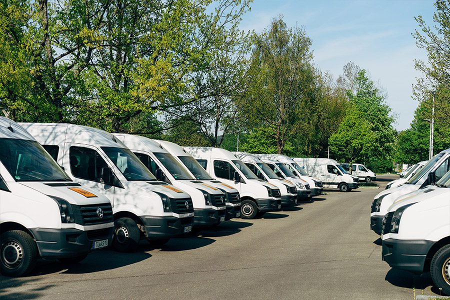 Insurance Telematics Discount for Businesses - White Vans Parked in a Parking Lot on a Sunny Day